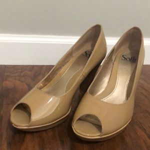 Nude patent leather heals with open toe.